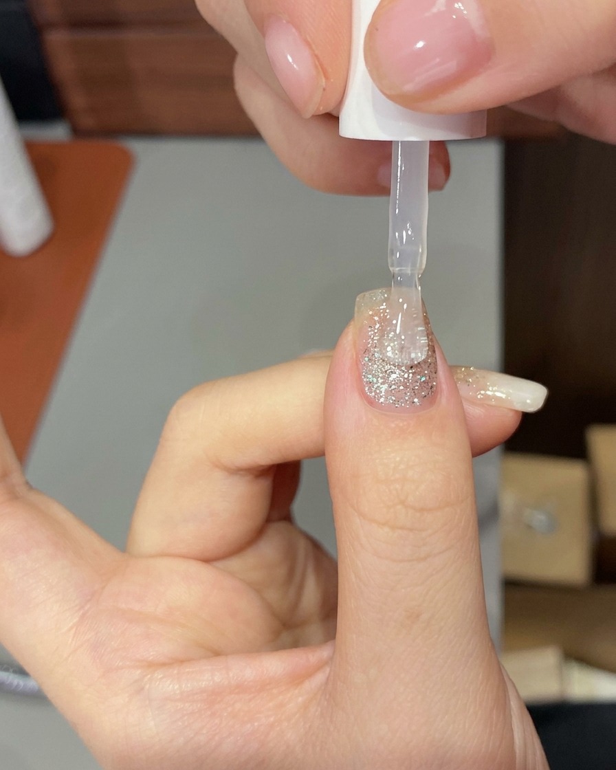 ビルダージェルを塗った手をUV/LEDネイルランプに入れて硬化させている様子。