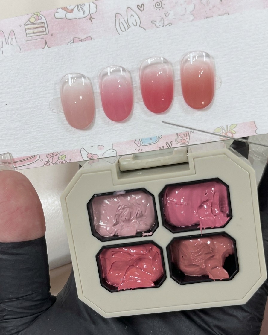 白いパレットの上に、小さなピンクのクレイジェルが準備されている様子。