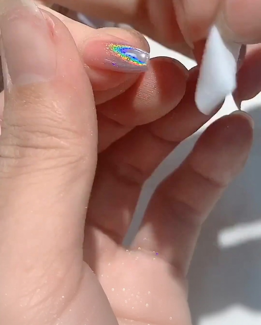 毛羽立たないワイプで爪の先端を綺麗に拭き取っている様子