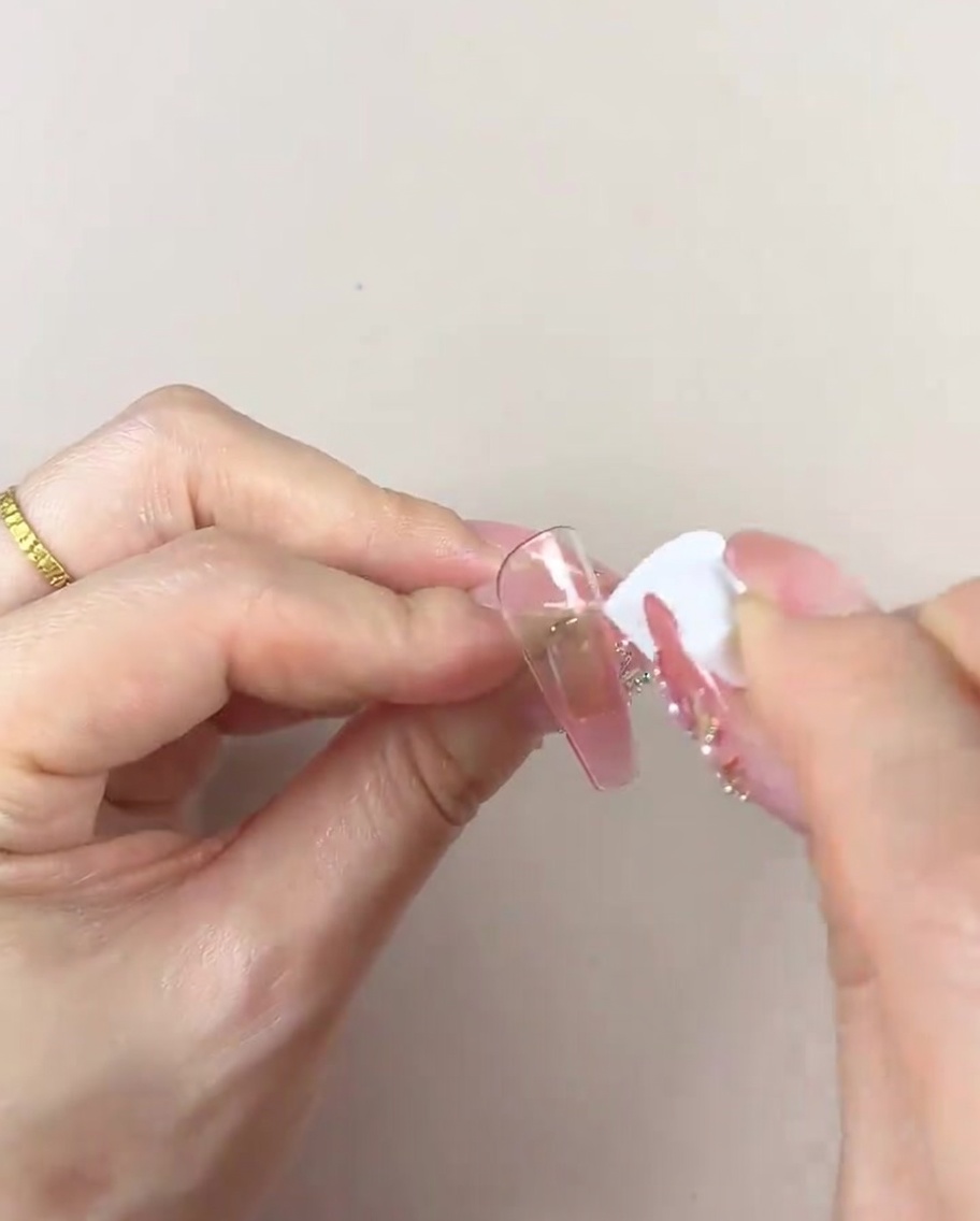 きれいなスポンジで、ネイルチップのグラデーションを整えている様子。