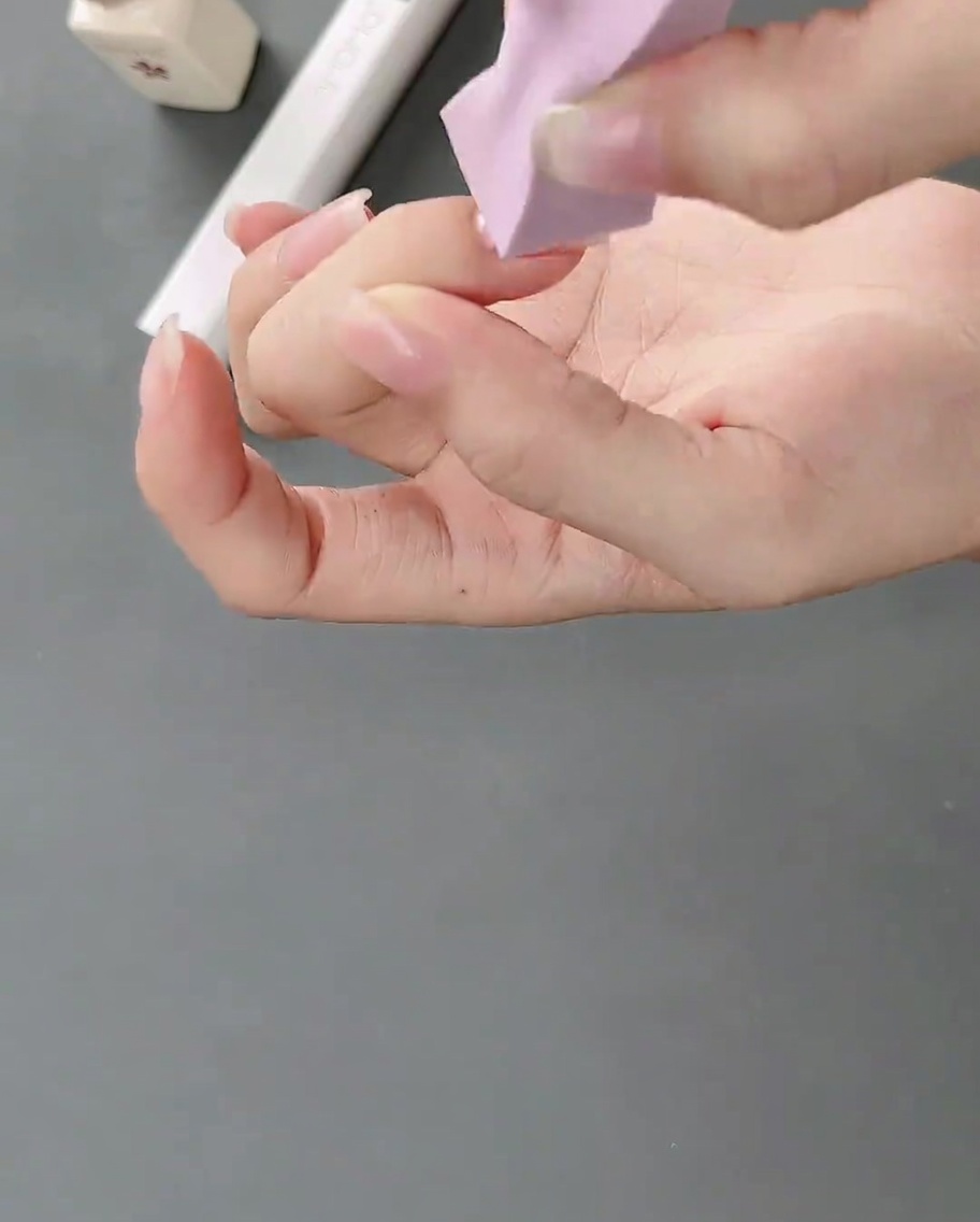 メイク用スポンジを使って自爪に白いジェルを叩き込み、柔らかなグラデーションを作る様子。