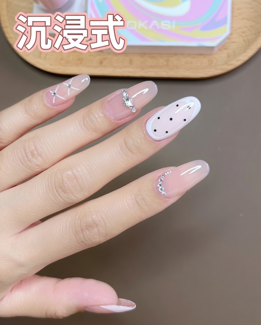 小指に細筆で白いジェルを使ってクロス模様を描いている様子