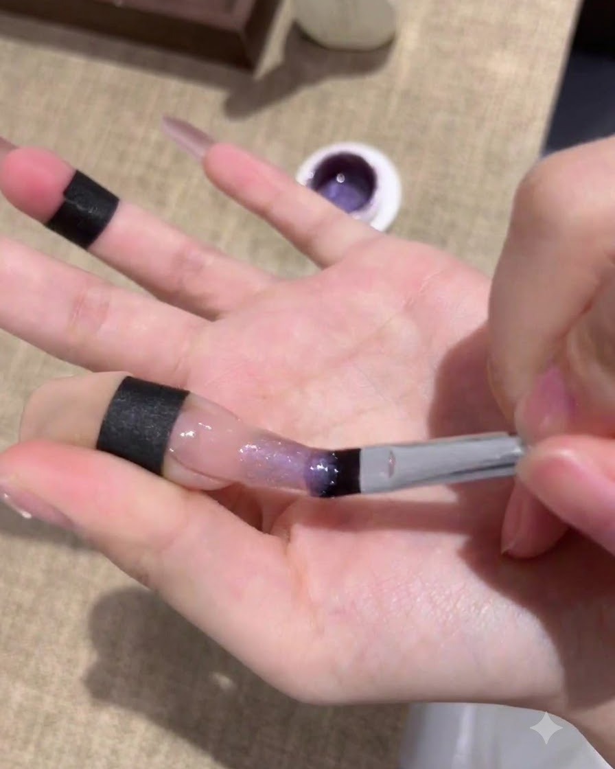 パープルキャッツアイジェルの1層目を塗った後、UV/LEDライトで硬化している爪。