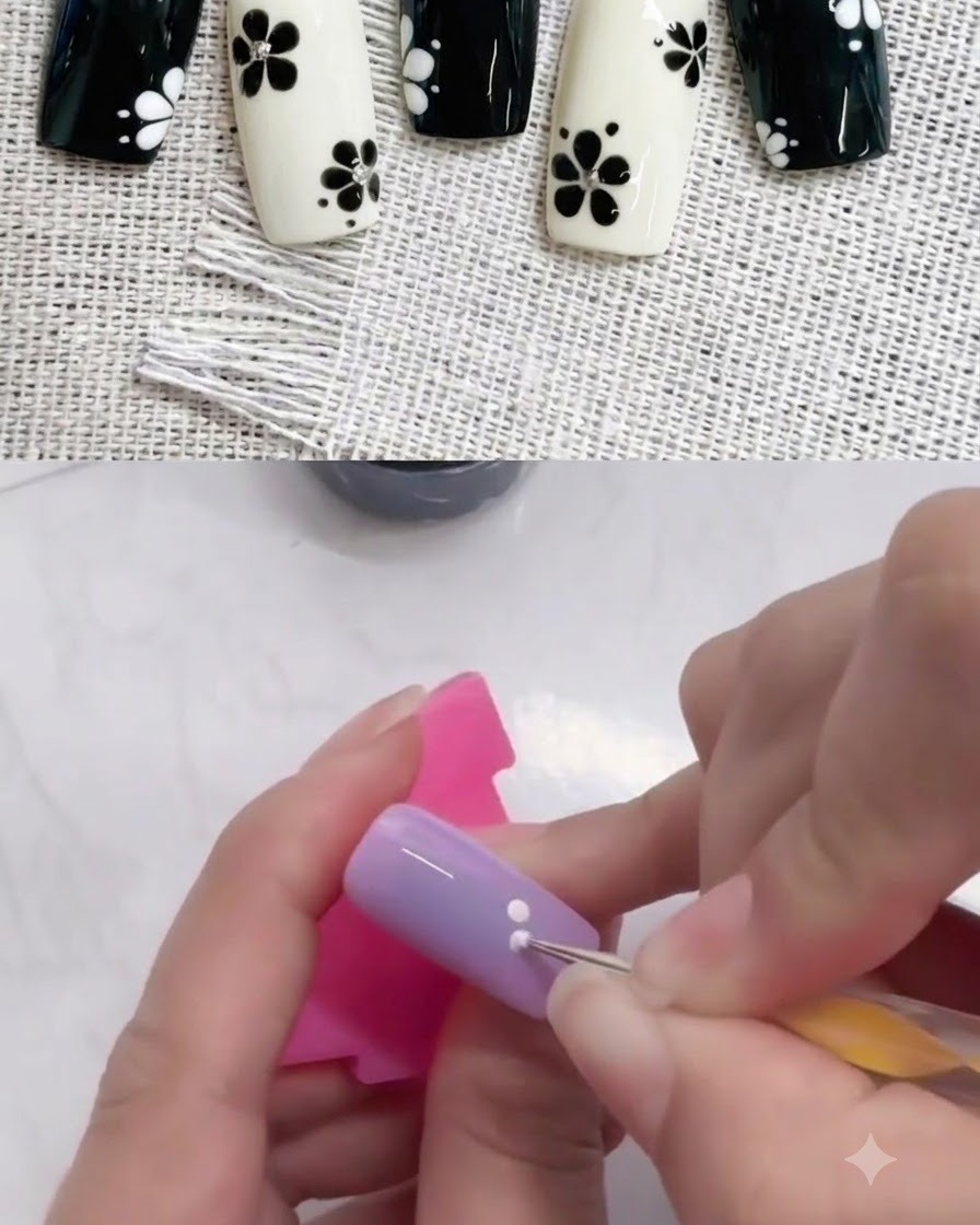 紫色のネイルの上で、ドットペンを使って1つ目のドットの隣に2つ目の白いドットを追加している様子。
