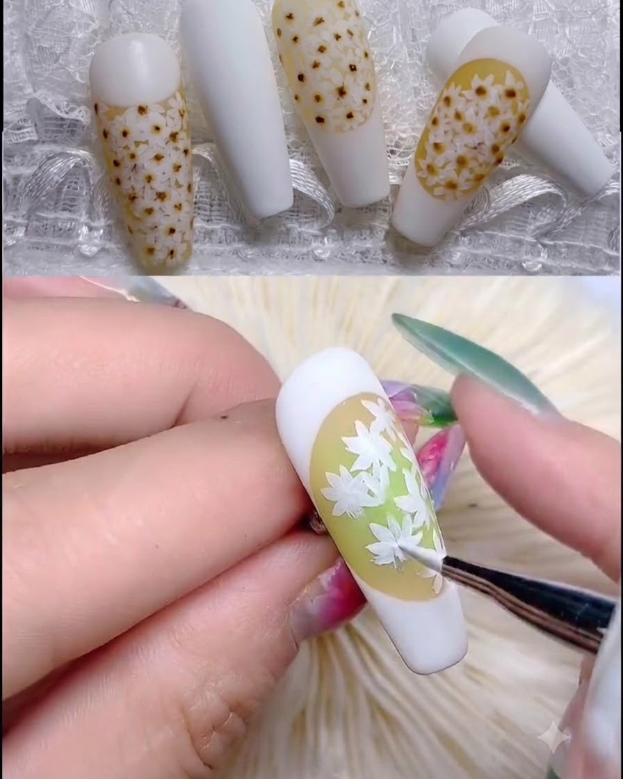 極細ブラシがデイジーの花びらの中心に薄いピンクの半透明のドットを適用している様子。