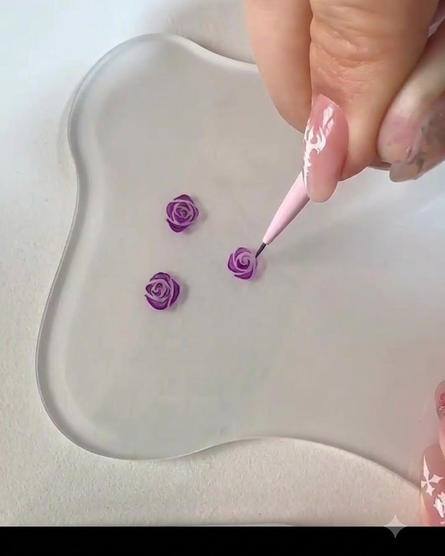 細筆を使い、隣接する湾曲したストロークを加えてパープルローズのつぼみの中心を完成させている画像。