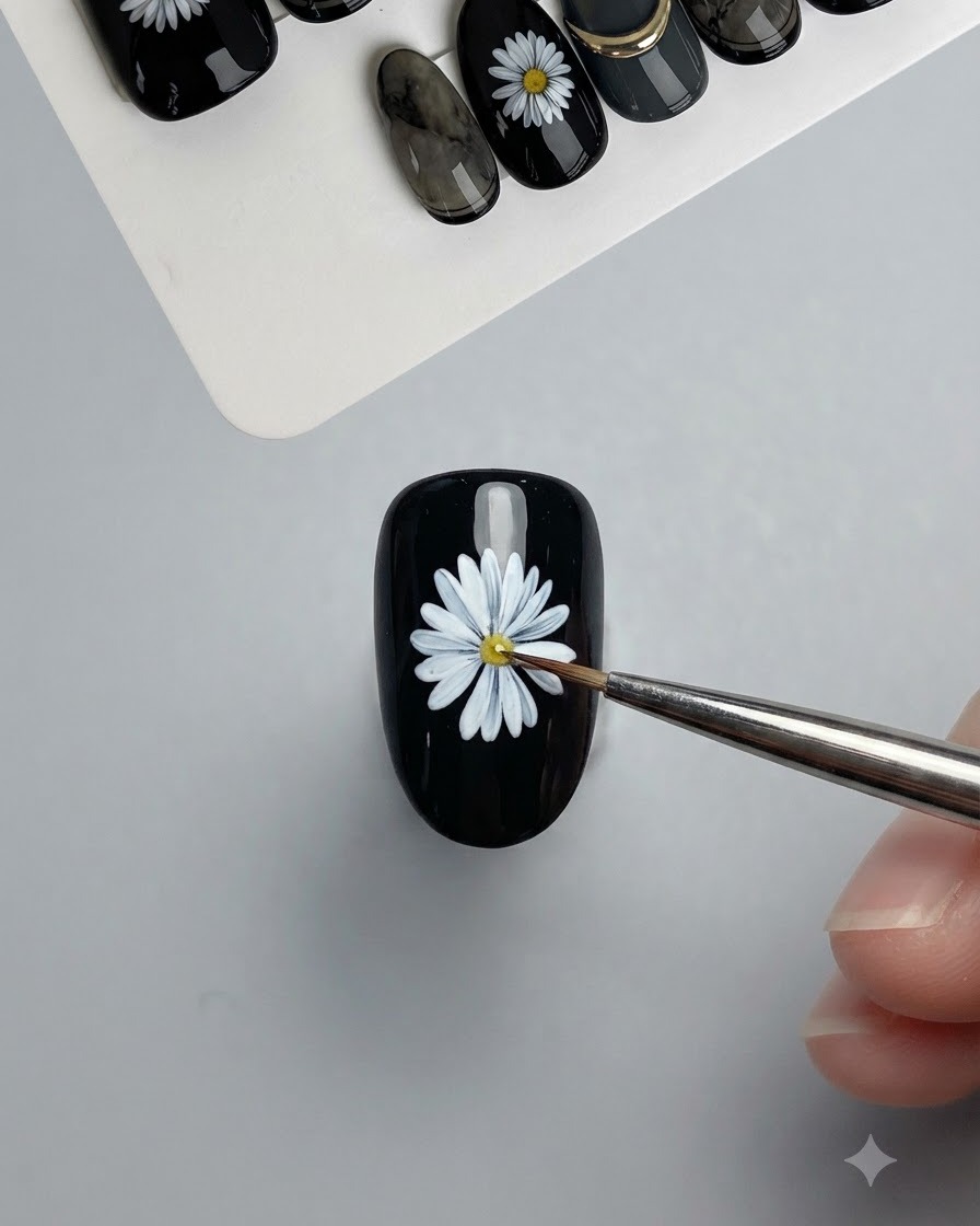 極細のライニングブラシで、描かれた白いデイジーの花びらの輪郭を細かく整えてシャープにしているところ。